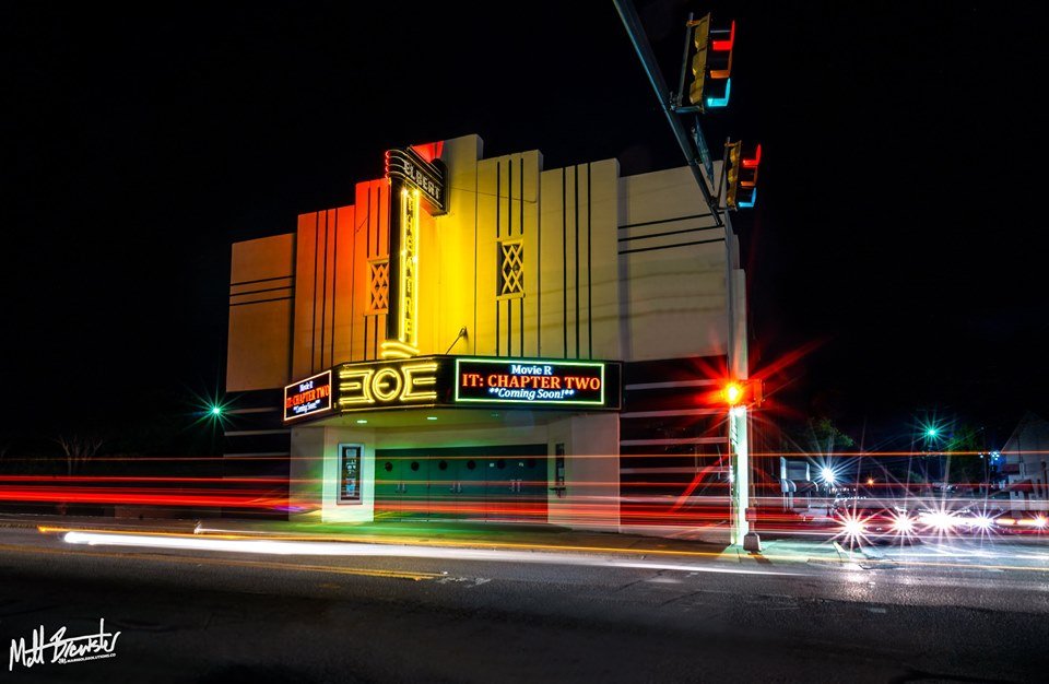 The Elbert Theatre at night with a marquee advertising “IT: Chapter Two” and light trails from passing cars.